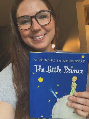 picture of woman holding book The Little Prince