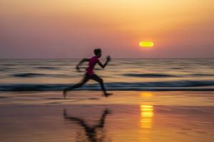 Blurred Runner in front of Water Photo by SwapnIl Dwivedi on Unsplash