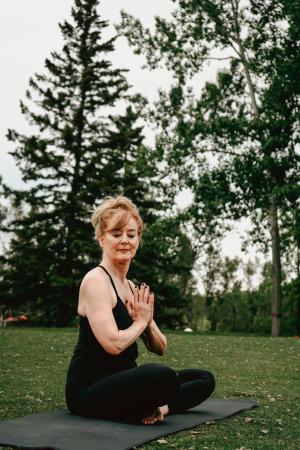 woman doing seated yoga outside