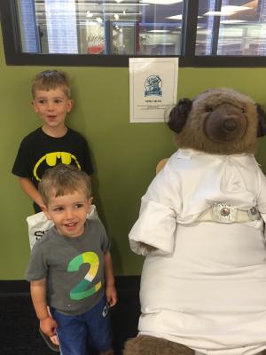 Thorndyke the Bear dressed as Princess Leia with some patron friends