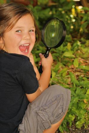 Child with Magnifying Glass in a Backyard -- 