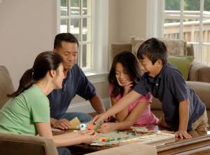 Family of four playing a board game. 